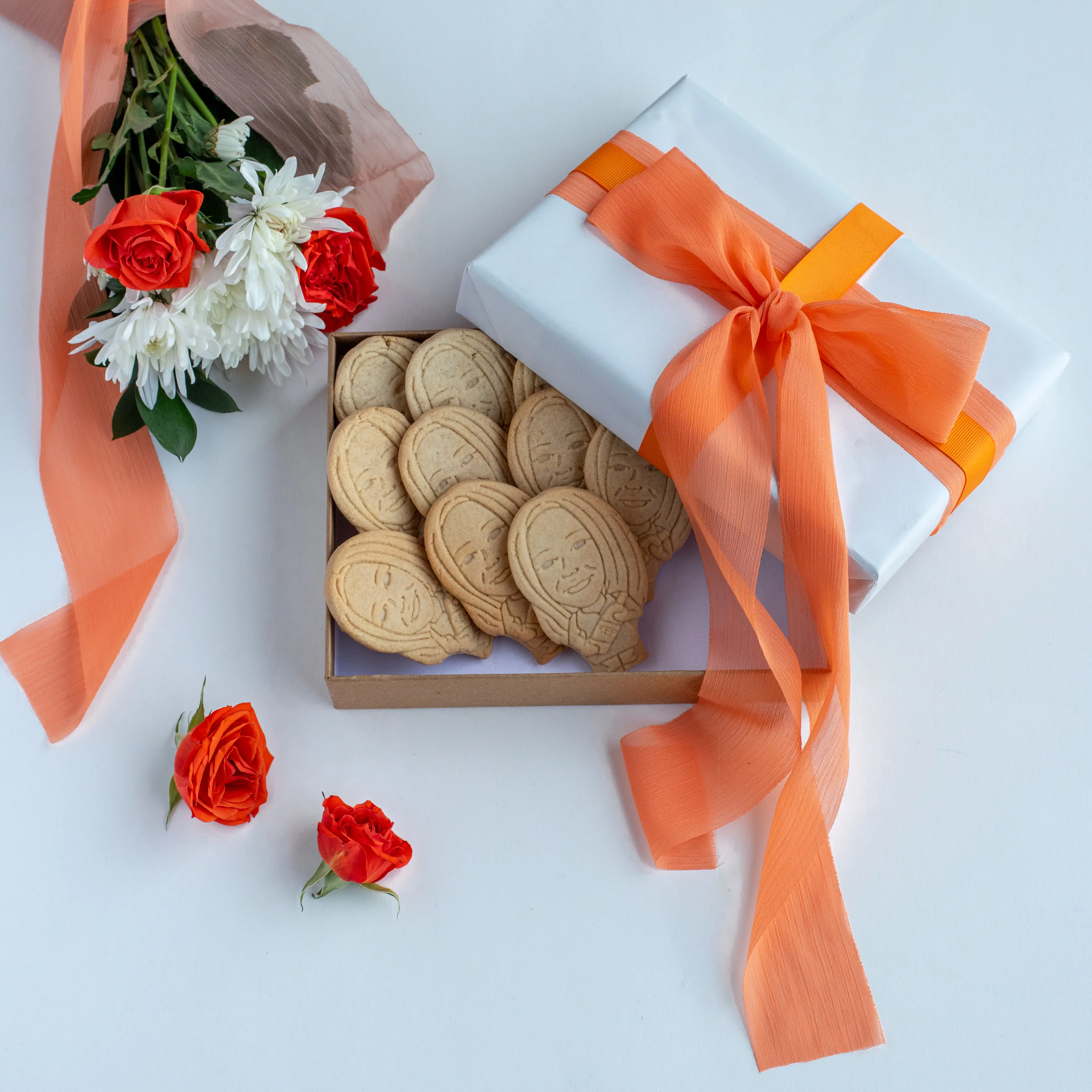 Custom face cookies in a gift box with orange ribbon and roses - the perfect personalized Mother's Day gift